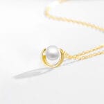 Gold discreet BDSM necklace with pearl for submissives, shown as elegant day collar jewelry.