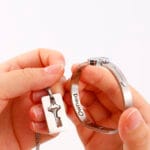 Couples lock key bracelet set engraved with “Good Girl.” Symbolic, permanent locking jewelry for submissives and Dominants in D/s relationships.