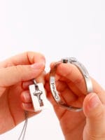 Couples lock key bracelet set engraved with “Good Girl.” Symbolic, permanent locking jewelry for submissives and Dominants in D/s relationships.
