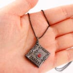 Daddys Little Slut necklace inside Black Gothic pendant engraved. A hidden message necklace for D/s dynamics, with dark romance and symbolism.