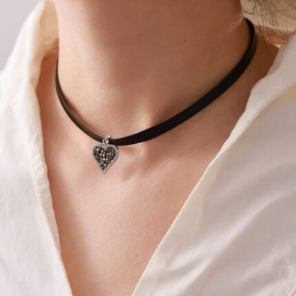 BDSM heart collar with triskelion back, leather band, and locking clasp — a discreet submissive collar blending devotion and pride for 24/7 ownership.
