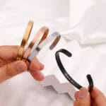 Hidden message bracelet Set of four hidden message BDSM cuff bracelets engraved with Good Girl, in black, silver, rose gold, and gold — discreet submissive jewelry.