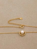 Gold discreet BDSM necklace with pearl for submissives, shown as elegant day collar jewelry.
