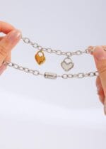 Lockable BDSM collar with silver chain, dual heart charms, and engraved hex lock clasp