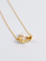 Gold discreet BDSM necklace with pearl for submissives, shown as elegant day collar jewelry.