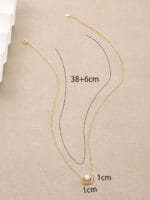 Gold discreet BDSM necklace with pearl for submissives, shown as elegant day collar jewelry.