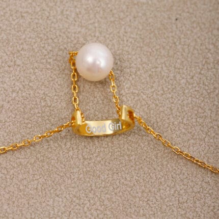 Gold discreet BDSM necklace with pearl for submissives, shown as elegant day collar jewelry.