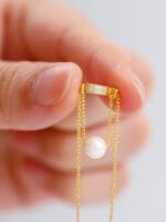 Gold discreet BDSM necklace with pearl for submissives, shown as elegant day collar jewelry.