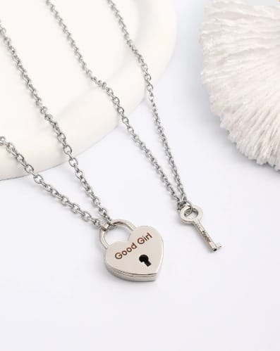 Heart-shaped "Good Girl" lock necklace with matching key, designed as a discreet BDSM collar for submissive daily wear.