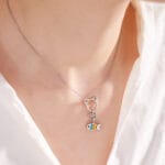 Stainless steel kitten play collar necklace with cat ear O-ring and rainbow fish charm – ideal as a discreet day collar or BDSM jewelry.