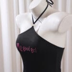 Collaring ceremony dress – black submissive gown with cut-out back and “My Good Girl” script for rituals.