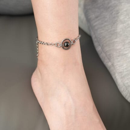 Triple O-ring submissive anklet with black pearl and engraved hex lock