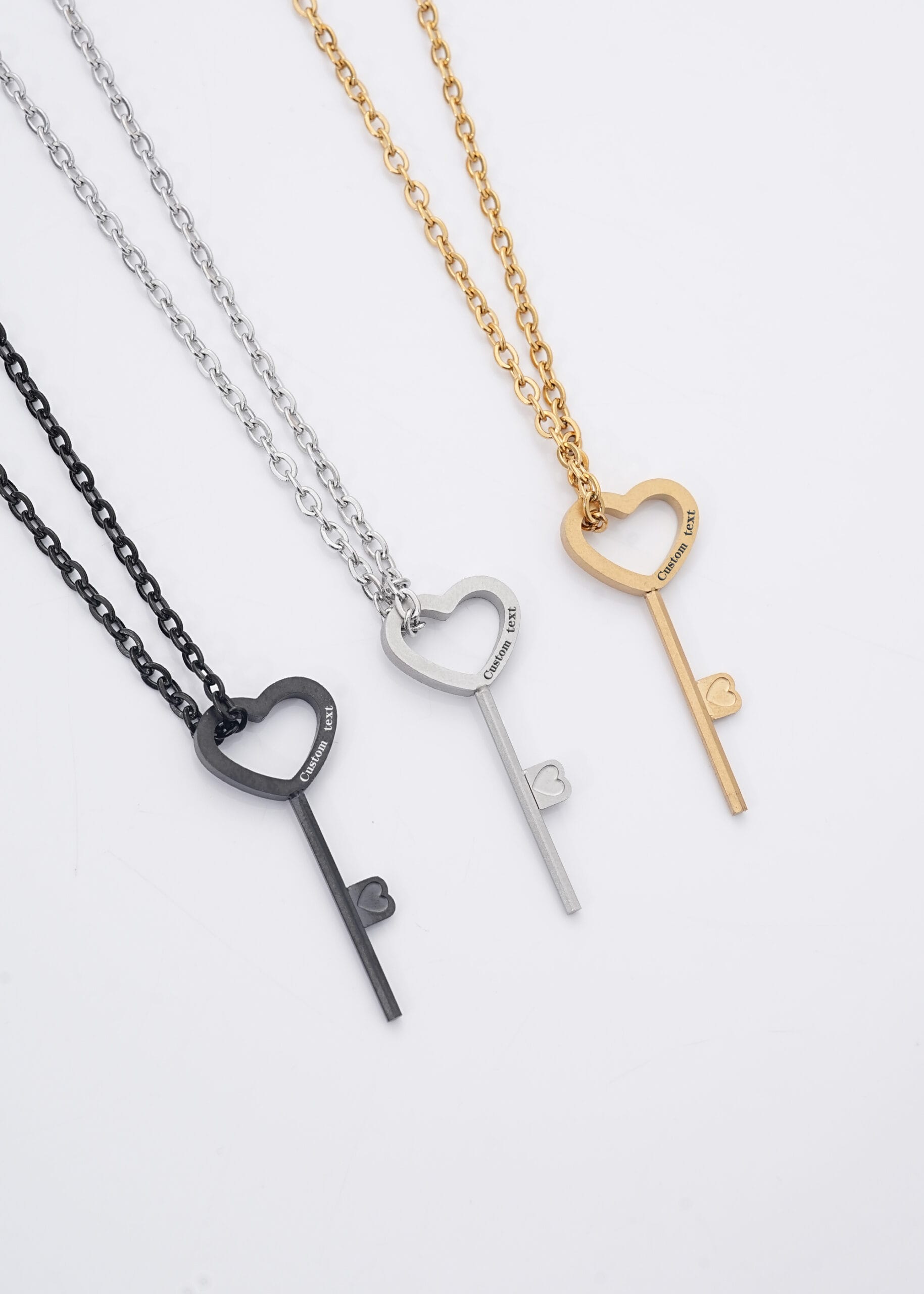 An engraved BDSM lock key in stainless steel, designed to open Classic Round and Flat Edge hex locks used in permanent locking collars.